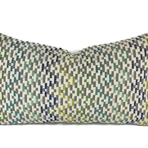 May include: A rectangular pillow with a geometric pattern in shades of green, blue, gray, and white.