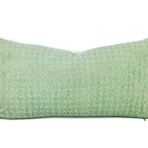 May include: A green and gold patterned lumbar pillow with a subtle geometric design.