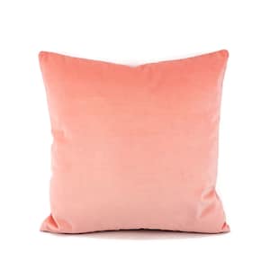 May include: A soft, peach-colored pillow with a smooth, velvety texture. The pillow is square-shaped and has a subtle sheen.