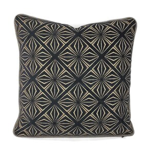 May include: A square throw pillow featuring a black fabric base with a repeating geometric diamond pattern in gold thread. The design consists of intersecting lines forming star-like shapes within each diamond, finished with a black and white piped edge.