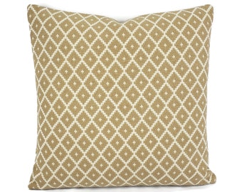 May include: A tan throw pillow with a white diamond pattern.