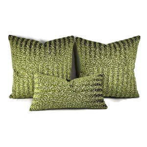 May include: Three green and white patterned throw pillows. The pillows are made of a soft, plush fabric and have a subtle sheen.