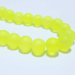 May include: A strand of bright yellow frosted round beads. The beads are strung together to form a necklace or bracelet.
