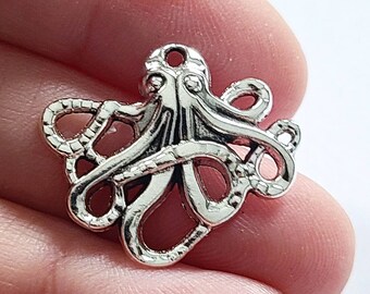 May include: Silver-toned metal octopus charm with detailed tentacles and a loop for attaching to jewelry or crafts.