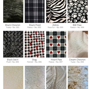 May include: A selection of fabric samples, featuring black chevron, plaid, zebra, and paw print fleece. Other fabrics include stag flannel, heart paw fleece, cream chevron, cream sherpa, ivory fuzzy, latte minky, and toffee fuzzy.