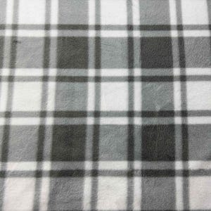 May include: A close-up of a soft, grey and white plaid fleece fabric. The pattern consists of intersecting lines forming squares and rectangles in varying shades of grey and white. The fabric has a fuzzy texture.