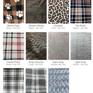 May include: A selection of fabric samples showcasing diverse patterns and textures. Includes a white paw print design on brown and black, a brown mink, cheetah print, and tan plaid. Other fabrics include cream plaid, gray chevron, dark gray sherpa, and light gray sherpa.