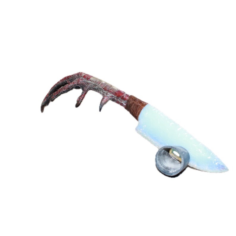 May include: A novelty knife featuring a bird claw handle, bound with brown twine, and a pale blue blade. A small, silver-coloured ring is at the base of the blade. The knife has a horror theme.