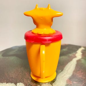 Vintage Whirley Industries Plastic Cow Creamer - bright orange & red, removable lid, handle grip, made in the USA.