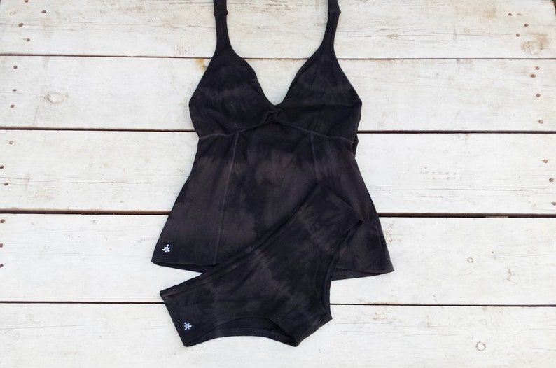 May include: A black tie-dye tank top and matching underwear set. The tank top has a V-neck and a knotted detail at the front. The underwear has a high-waisted fit.