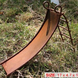 May include: A rusty metal miniature slide and ladder set for a fairy garden. The slide is 17 cm long, 4.7 cm wide, and 12.5 cm high.
