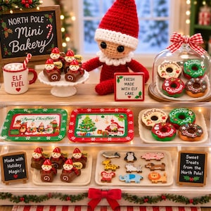 May include: A miniature bakery display case featuring a crocheted elf doll, a mug labeled Elf Fuel, and various holiday-themed treats. The display includes trays of decorated donuts, animal-shaped cookies, and chocolate logs, with signs reading North Pole Mini Bakery, Fresh Made With Elf Care, Made with Holiday Magic, and Sweet Treats from the North Pole.