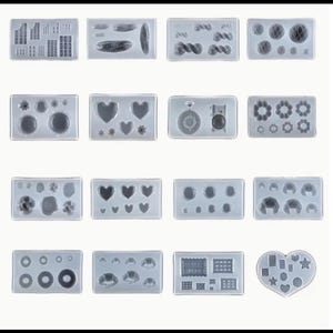 May include: Set of 10 silicone molds for crafting. The molds feature various shapes, including hearts, stars, donuts, and geometric designs.