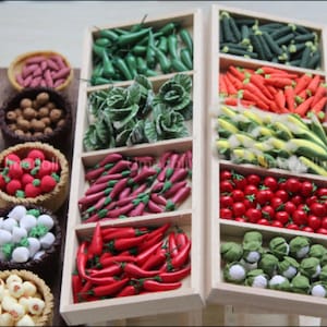 May include: A miniature wooden market stall with various miniature vegetables and fruits, including green peppers, red peppers, cabbage, carrots, corn, tomatoes, and cauliflower.