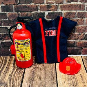 May include: A red plastic squirt gun toy shaped like a fire extinguisher with the words "Top Deluxe Squirt Gun" and "No. 1211" printed on the side. A blue and red firefighter costume with the words "Elf Department Fire" printed on the front. A red plastic firefighter hat with a yellow emblem.
