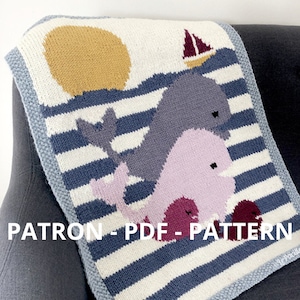 May include: Knitted baby blanket with a blue and white striped background, featuring two whales, a yellow sun, and a red sailboat. The blanket has the text "PATRON - PDF - PATTERN" at the bottom.