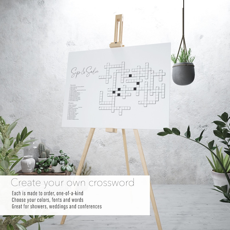 May include: A white crossword puzzle on an easel with the words "Sip & Satie" at the top. The text below the puzzle reads "Create your own crossword. Each is made to order, one-of-a-kind. Choose your colors, fonts and words. Great for showers, weddings and conferences."