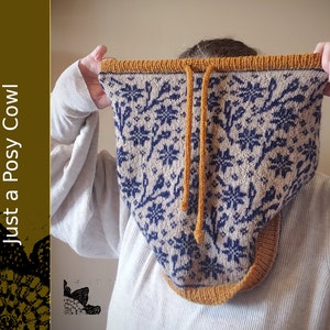 May include: A knitted cowl with a floral pattern in navy and beige, with a mustard drawstring and trim. The text "Knit Pattern Just a Posy Cowl" is visible on the left side of the image.
