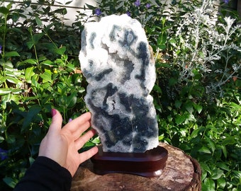 Huge Agate Crystal Geode Slice specimen on wood display stand. Green eyes and sparkling rainbow points.