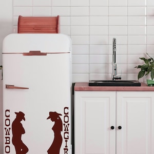 Western wall art styled as a restroom door sign, a cowboy and cowgirl silhouette design that fits rustic farmhouse bathrooms.