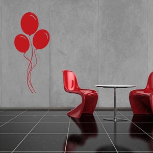 Silhouette art of clustered balloons adds lightness and movement to any youth-inspired wall display.