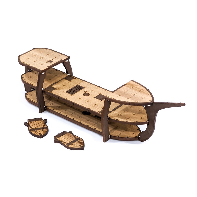 May include: A wooden ship model kit with three levels, two small boats, and a brown wooden base.