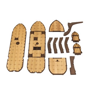 May include: A wooden ship model kit with multiple pieces, including the hull, deck, and sails. The pieces are made of light brown wood and have a natural finish.