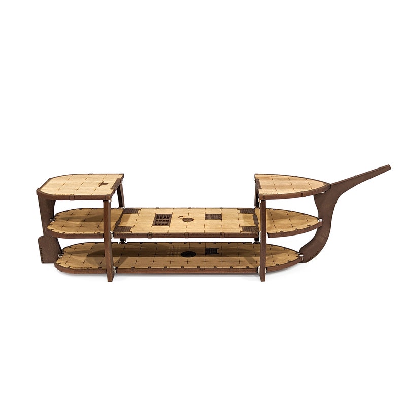 May include: A wooden ship model kit with three levels of decks. The kit is unassembled and shows the individual pieces.