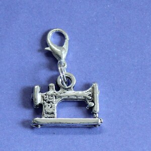 May include: Silver charm in the shape of a vintage sewing machine with a silver lobster clasp.