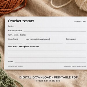 May include: A white rectangular project card titled Crochet restart with fields for project, pattern, yarn, hook size, row, stitch count, and notes. The card includes the text Nestled Page Studio, Project Card, and More room? Use the project record.