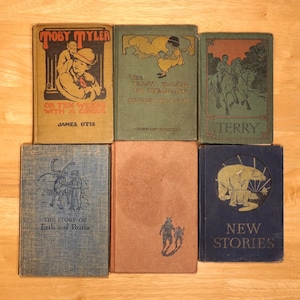 May include: A collection of six vintage children's books with colorful covers. The books are titled "Toby Tyler or Ten Weeks with a Circus", "The Easy Road to Reading Second Reader", "Terry", "The Story of Erik and Britta", "New Stories", and an untitled book.