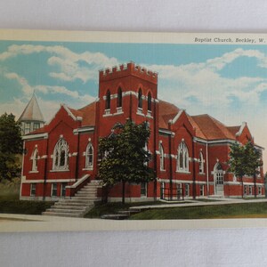 May include: A vintage postcard showing a red brick Baptist Church in Beckley, West Virginia. The church has a tall spire and a large, arched entrance. The postcard is in good condition and has a faded, vintage appearance.
