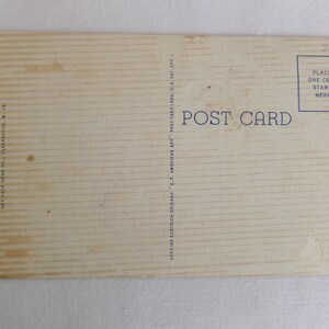 May include: A vintage postcard with a white background and blue text that reads "POST CARD". The postcard has a place for a stamp and the text "PLACE ONE CENT STAMP HERE".