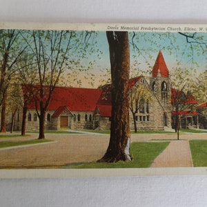 May include: A vintage postcard showing the Davis Memorial Presbyterian Church in Elkins, West Virginia. The church is a stone building with a red roof and a tall spire. The postcard is in good condition with some slight wear and tear.