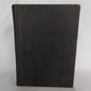 May include: A black hardcover book with a plain cover.