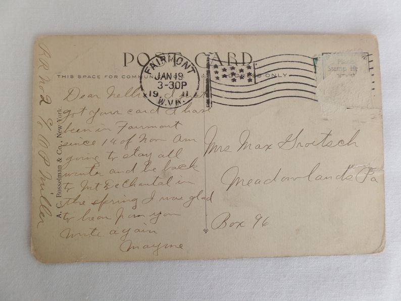 May include: A vintage postcard with a handwritten message. The postcard is addressed to Mrs. Max Groetsch, Box 96, Meadowlands, PA. The message reads, "Dear Helen, got your card & have been in Fairmont since 14 of Jan. Am going to stay all winter and be back to Int. & Chantal in the spring. I was glad to hear from you. Write again. Mayme."