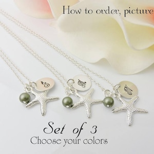 May include: Set of three silver necklaces with a starfish charm and a small pearl. Each necklace has a personalized disc with the letters 'S', 'M', and 'C' engraved on them.  'Set of 3' and 'Choose your colors' are written below the necklaces.