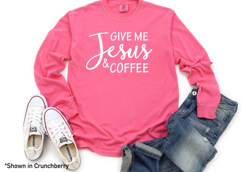 May include: Pink long-sleeve t-shirt with the text "Give me Jesus & Coffee" in white lettering.