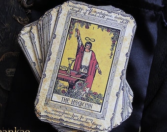 May include: A vintage tarot card deck with the Magician card face up. The card is yellow with a black border and features a man in a red robe holding a wand. The card text reads "The Magician" and includes keywords like "creativity, self-confidence, dexterity, sleight of hand, will-power, skill, delay, unimaginative, insecurity, lack self-confidence".