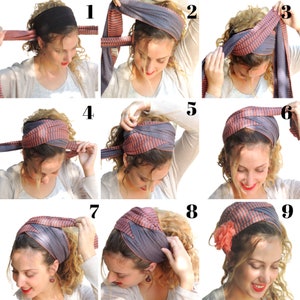 May include: A step-by-step guide on how to tie a striped head scarf. The scarf is gray with orange stripes. The model has curly hair and is wearing a white shirt.