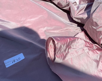 May include: A close-up of a pale pink silk fabric with a white label that reads "silks4less.com Article # 1530".