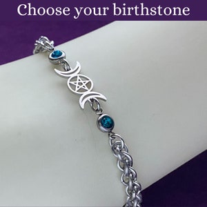 May include: A silver chain bracelet with a triple moon and pentacle charm and two turquoise blue crystals.  Choose your birthstone.