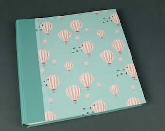 Large square photo album in apricot green turquoise with small hot air balloons
