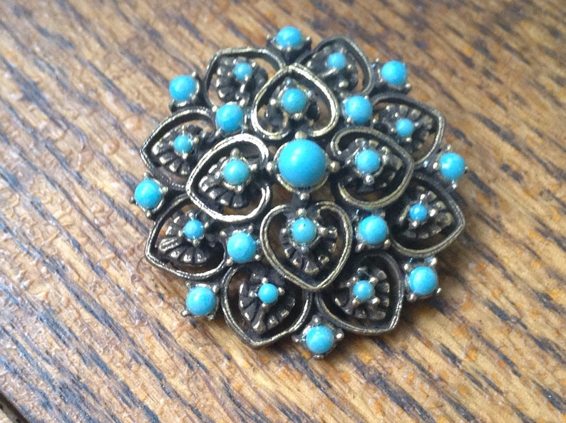 Blue and goldtone costume pin