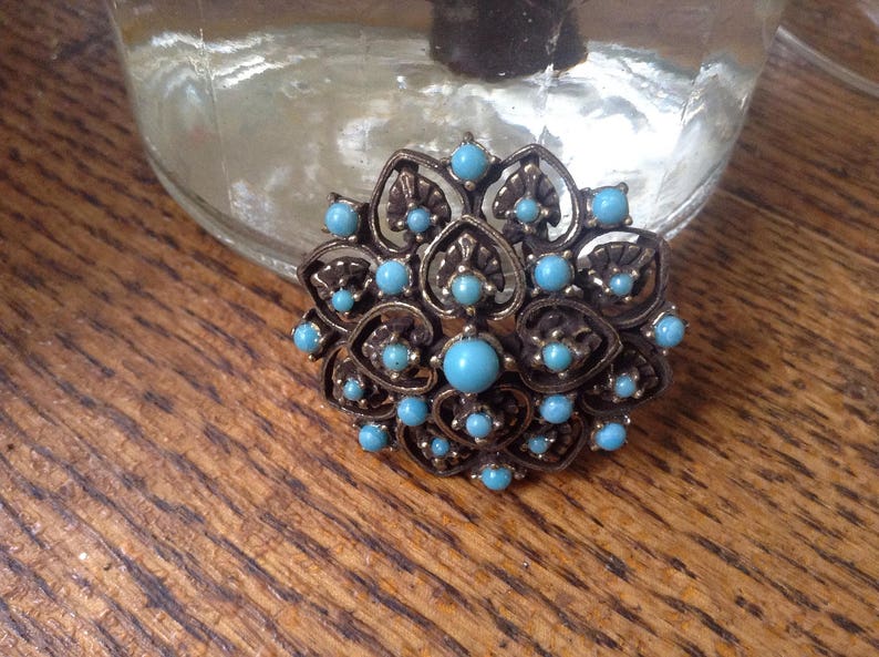 Blue and goldtone costume pin