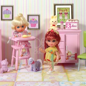 May include: A pink dollhouse nursery with two dolls, a crib, a high chair, a changing table, and a green chair. The dolls are wearing pink and yellow dresses. The nursery has a pink and white striped wallpaper and a pink rug.