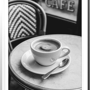 May include: A black and white image of a cup of coffee on a saucer with a spoon, on a marble table. The word "CAFE" is visible in the background. A chair with a black and white pattern is also in the background.