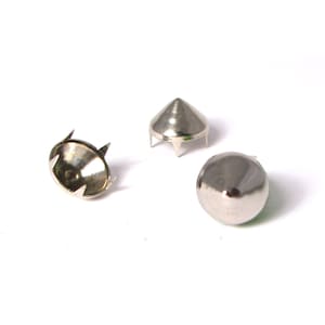 May include: Three silver metal pyramid-shaped studs with a pointed top. The studs have a flat base with four prongs.