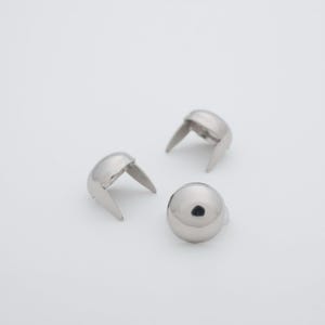 May include: Three silver metal dome-shaped studs with prongs. The studs are used for leather craft and other DIY projects.