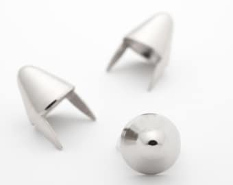 May include: Three silver metal cone-shaped rivets with a round head. The rivets are used for attaching fabric or leather to other materials.